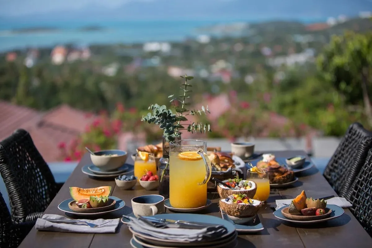 Long table set for a shared meal over the coast