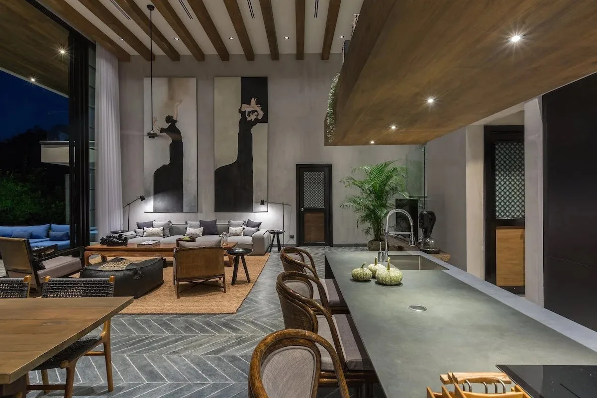 The kitchen and living space at night, open to the terrace